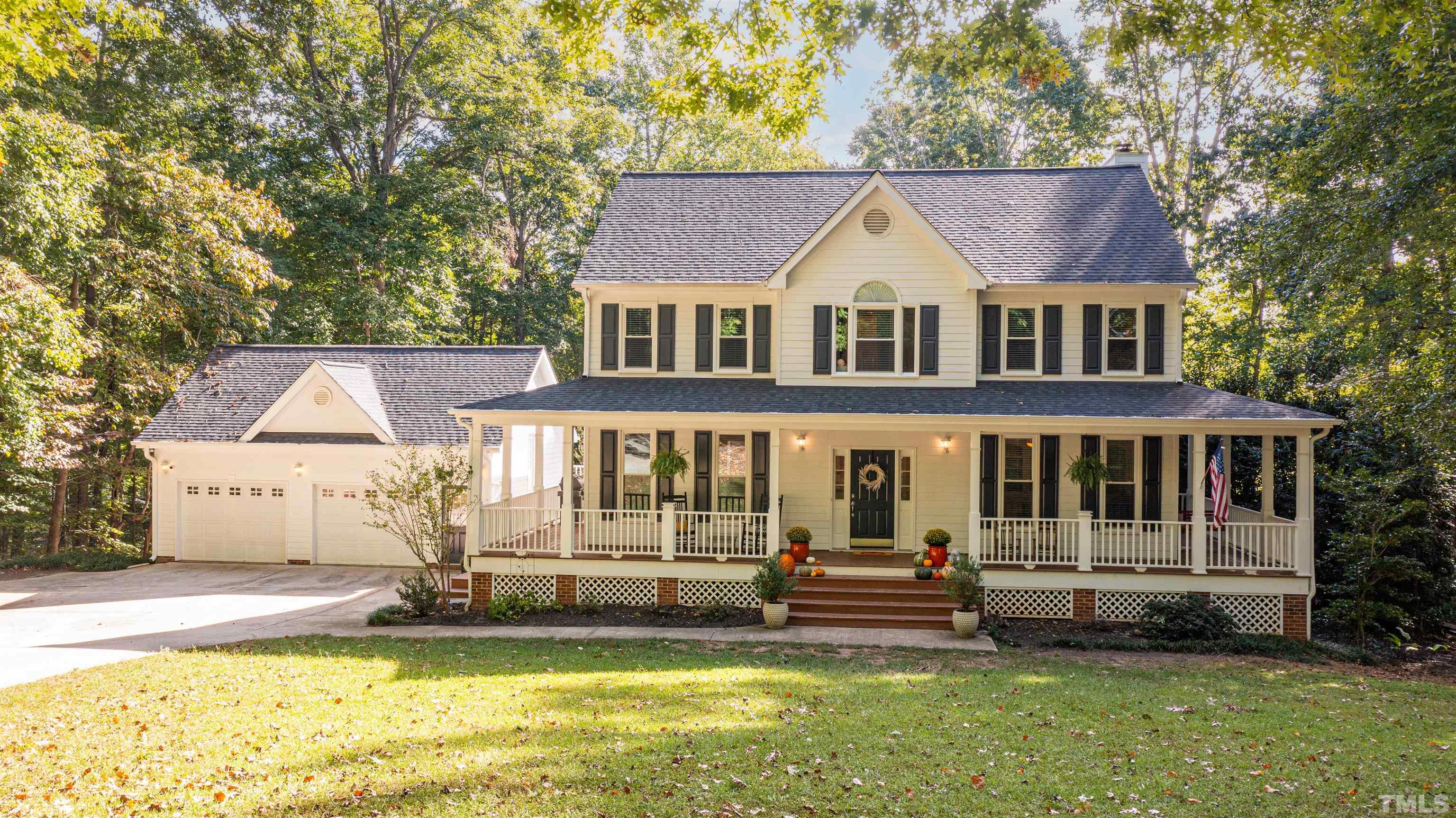 11308 Derby Lane Raleigh, NC 27613 - Photo 40 of 42 a view of a house with garden and trees in the background