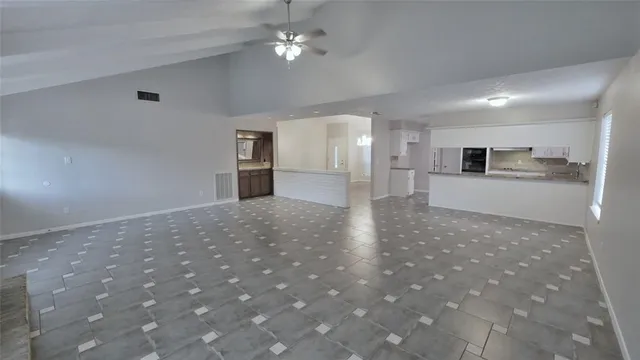 a view of a kitchen with a sink and a refrigerator
