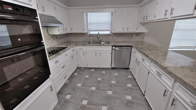 a kitchen with a sink stove and cabinets