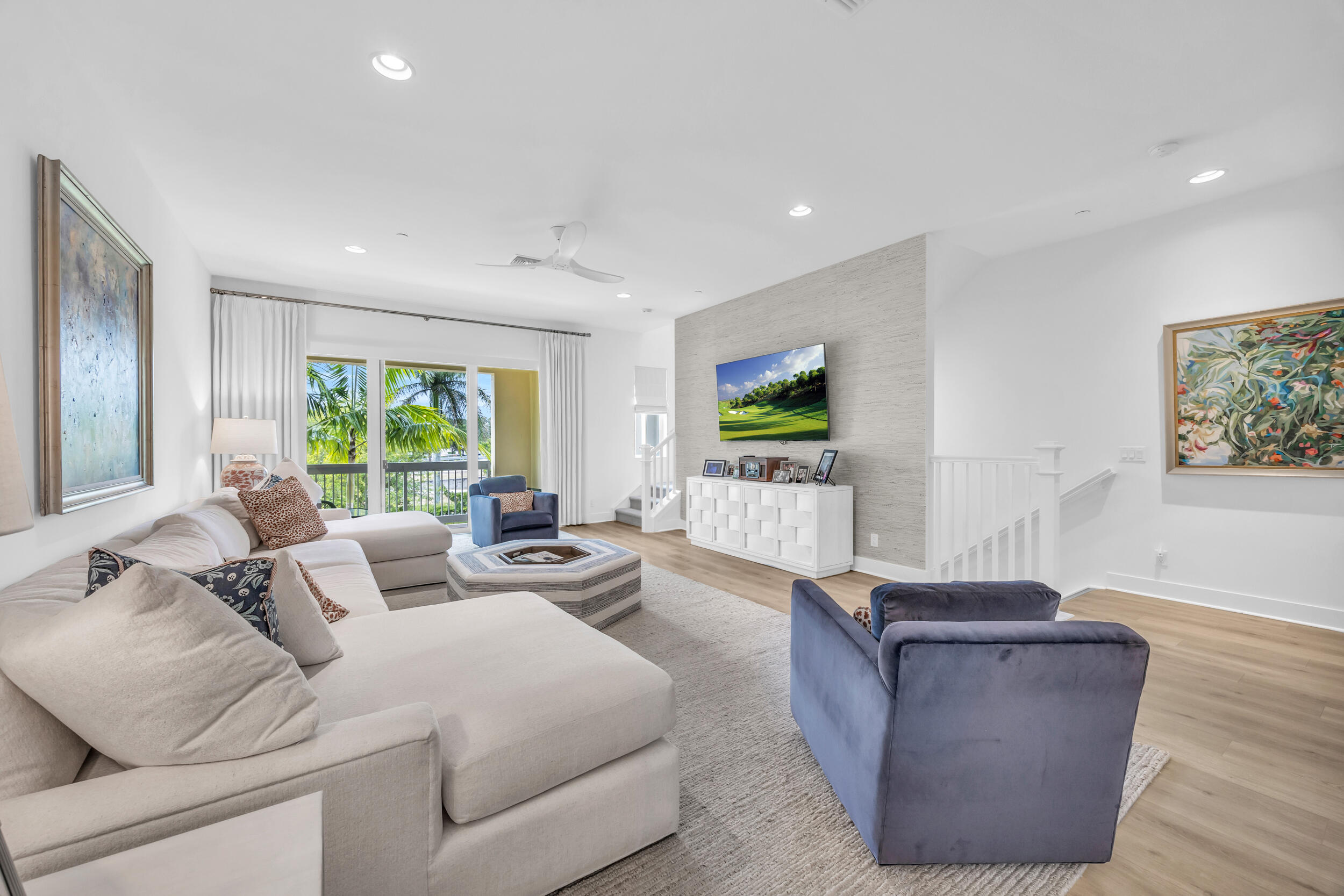 12554 Gross Pointe Road Palm Beach Gardens, FL 33418 - Photo 11 of 39 a living room with furniture and a flat screen tv