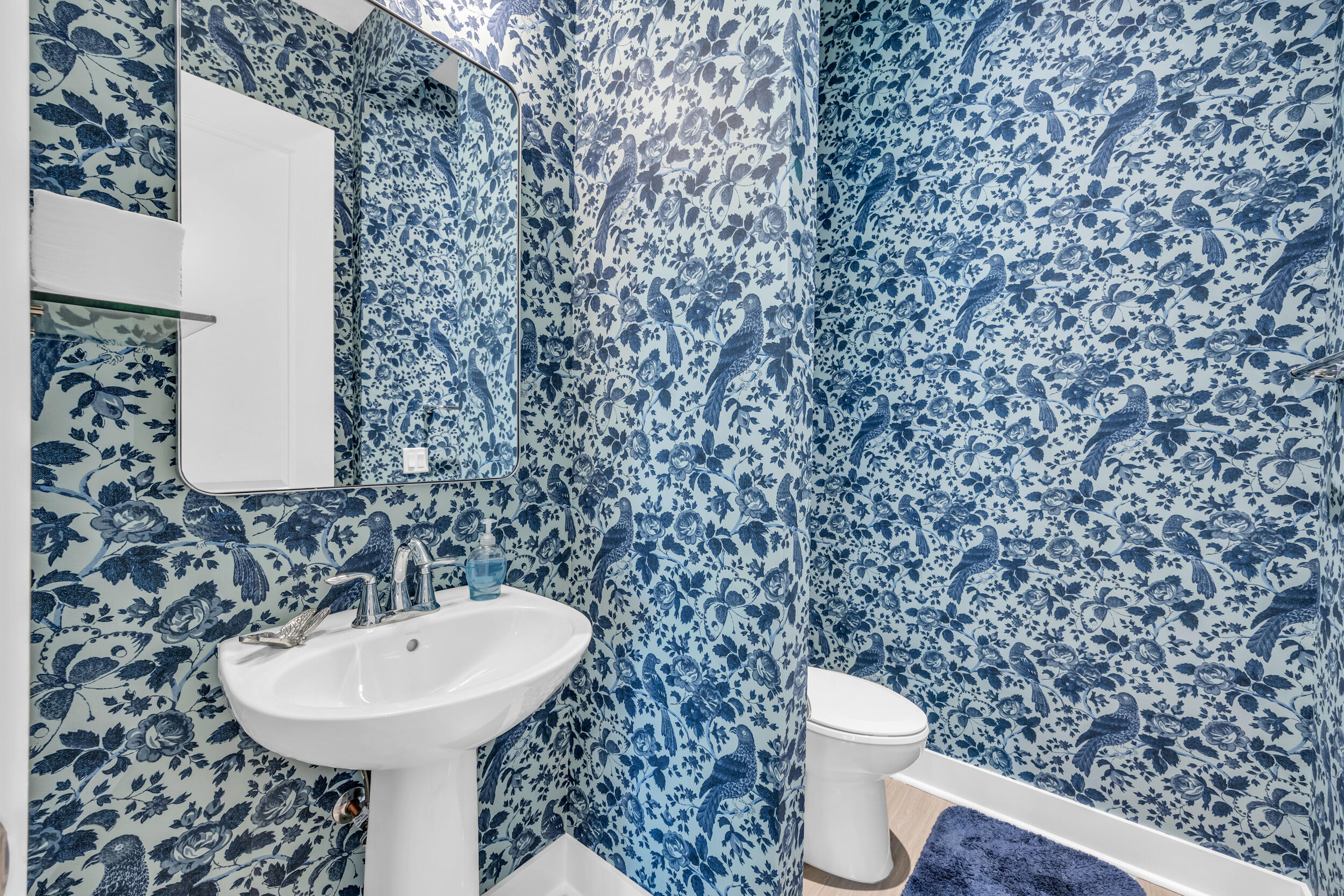 12554 Gross Pointe Road Palm Beach Gardens, FL 33418 - Photo 20 of 39 a bathroom with a sink a toilet and a mirror