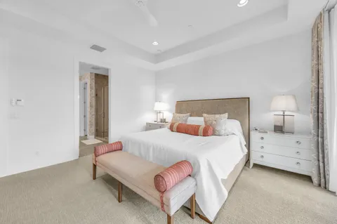 a spacious bedroom with a bed and a flat screen tv