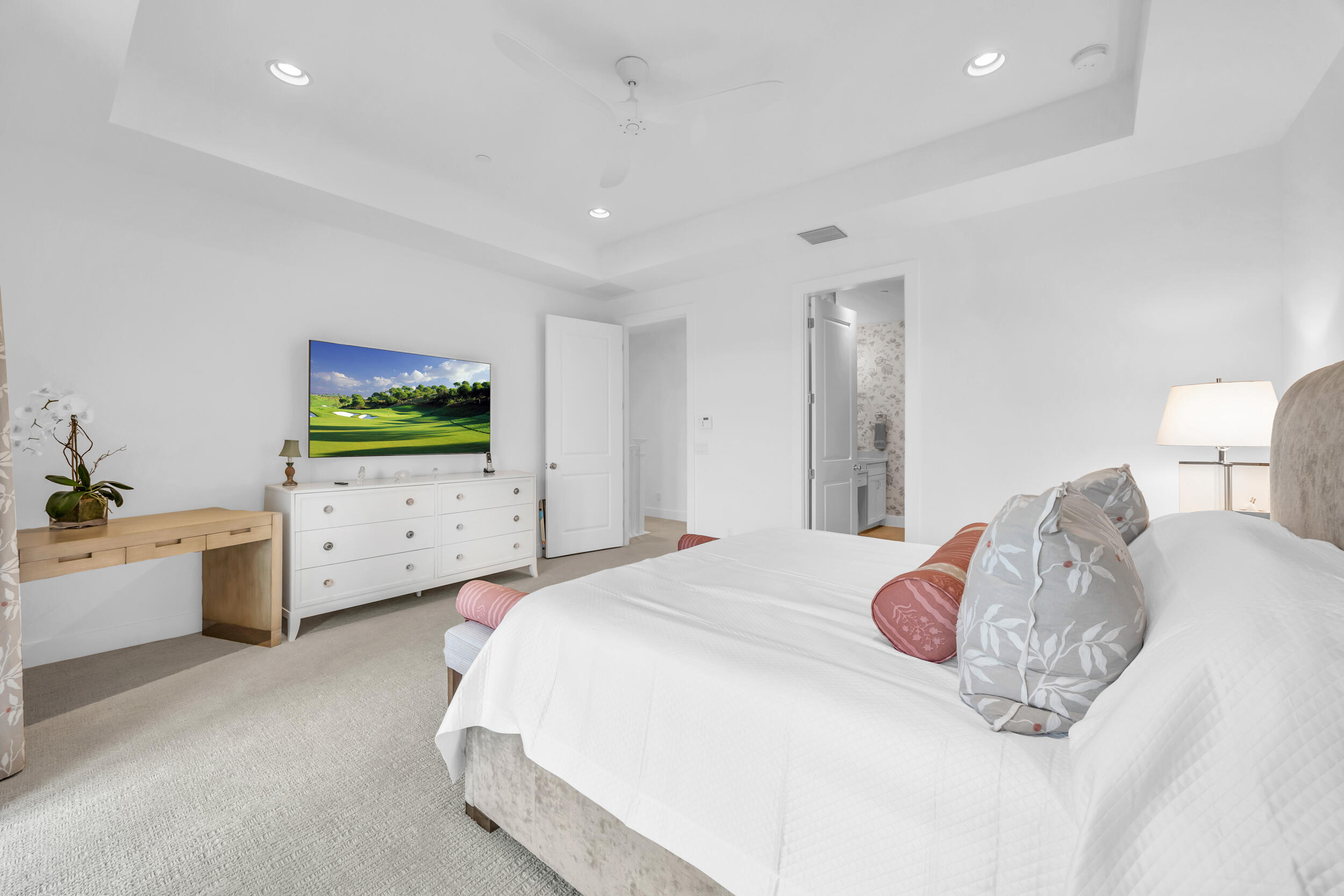 12554 Gross Pointe Road Palm Beach Gardens, FL 33418 - Photo 26 of 39 a spacious bedroom with a bed and a flat screen tv