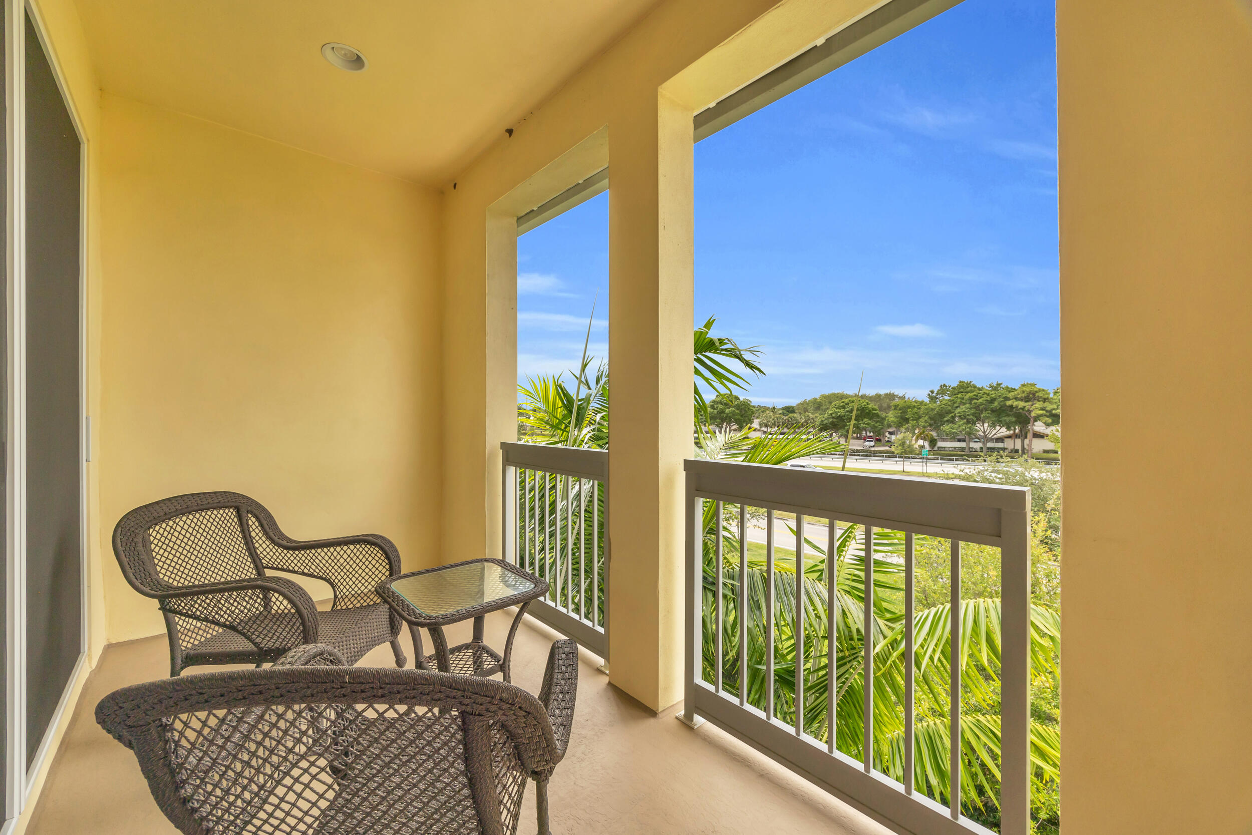 12554 Gross Pointe Road Palm Beach Gardens, FL 33418 - Photo 30 of 39 a view of a balcony with furniture and floor to ceiling window