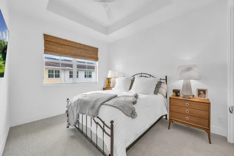 a bedroom with a bed and painting on the wall