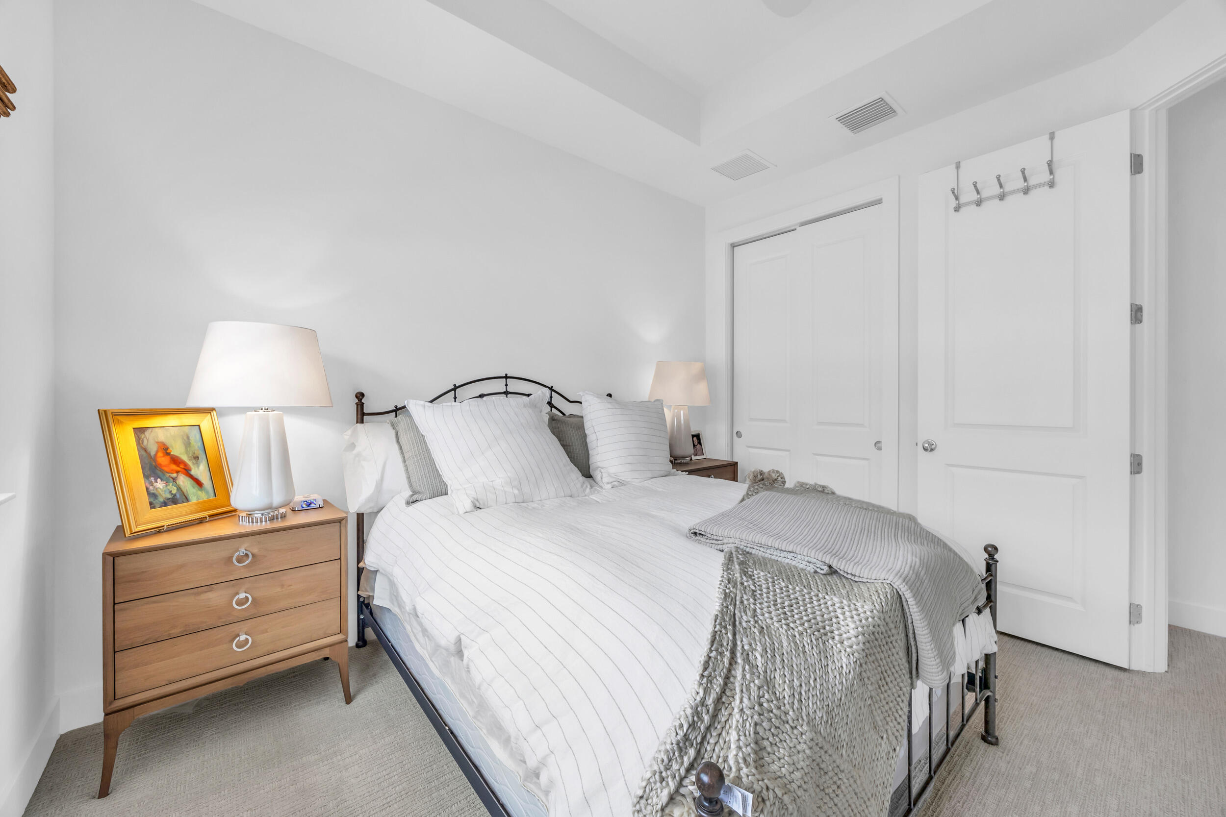 12554 Gross Pointe Road Palm Beach Gardens, FL 33418 - Photo 33 of 39 a bedroom with a bed and painting on the wall