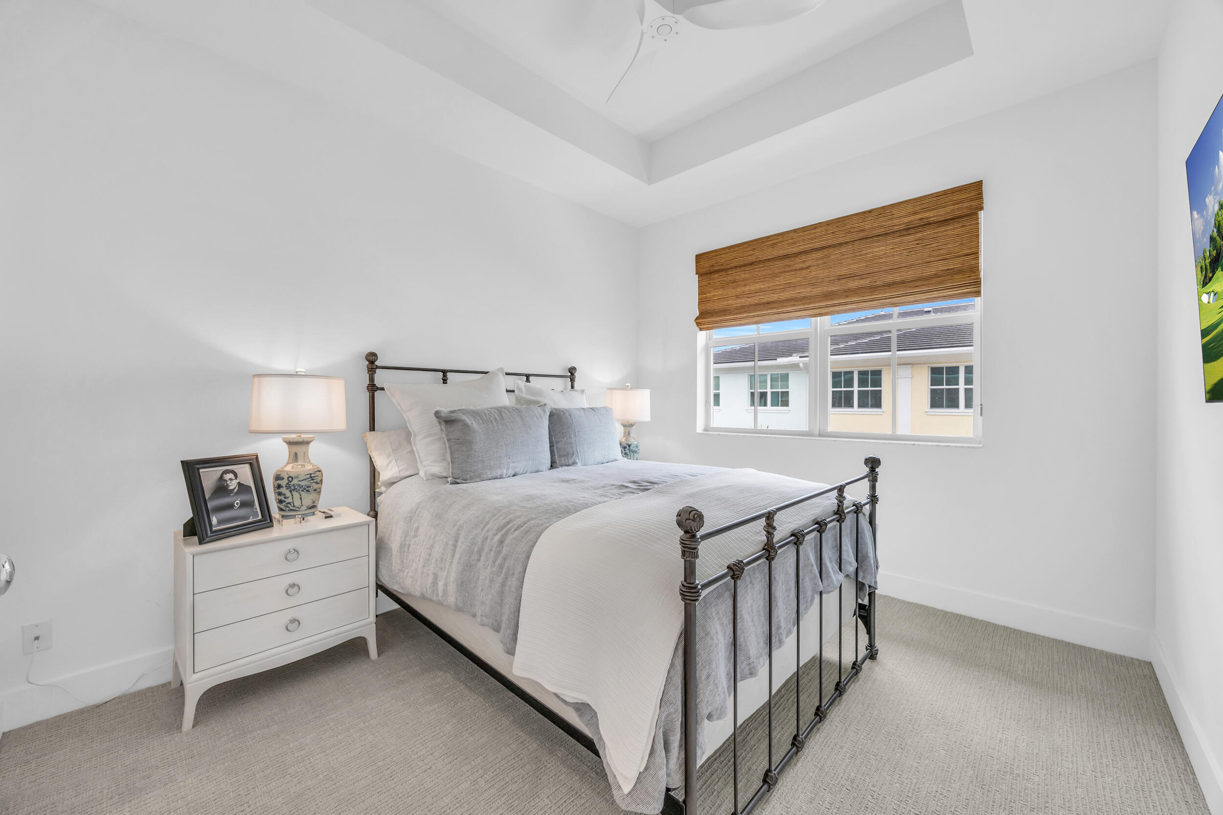 12554 Gross Pointe Road Palm Beach Gardens, FL 33418 - Photo 35 of 39 a bedroom with a bed and a night stand