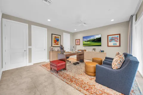 a living room with furniture a flat screen tv and rug