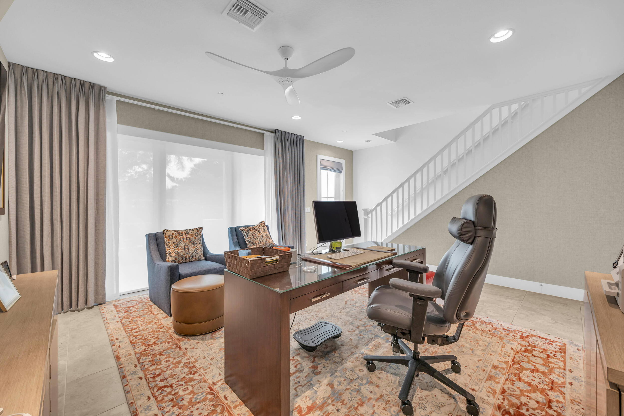 12554 Gross Pointe Road Palm Beach Gardens, FL 33418 - Photo 7 of 39 a living room with furniture and a flat screen tv