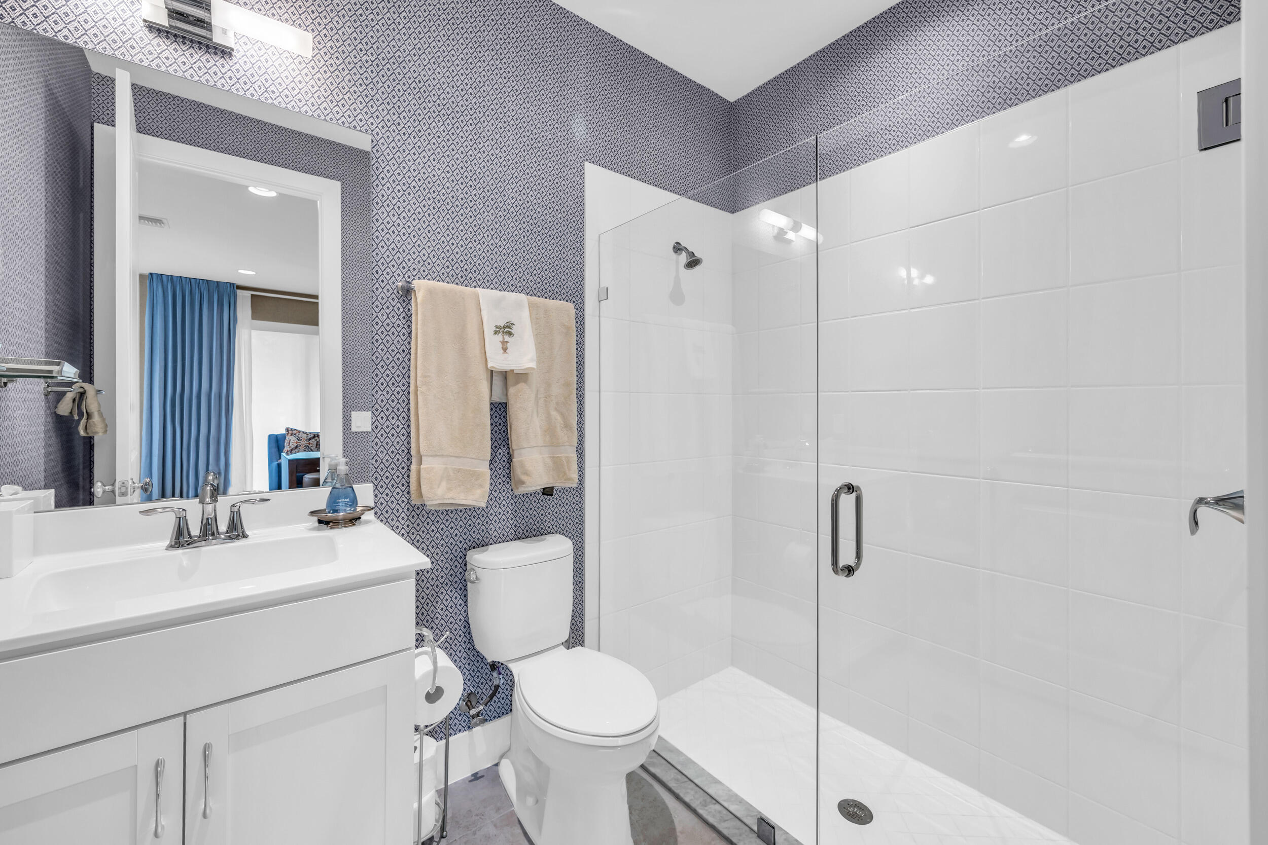 12554 Gross Pointe Road Palm Beach Gardens, FL 33418 - Photo 9 of 39 a bathroom with a sink toilet and shower