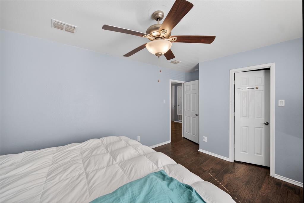 9633 Anns Way Plano, TX 75025 - Photo 25 of 37 a bedroom with a bed and a chandelier