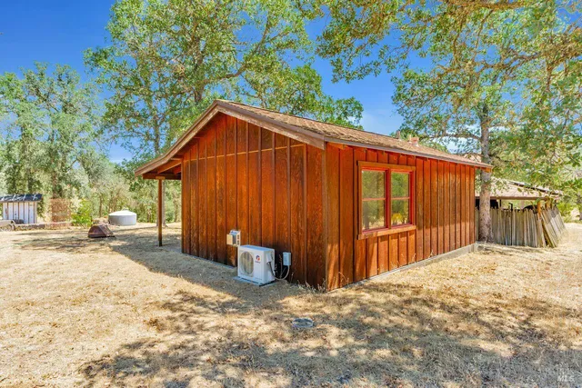 a backyard of a house with table and chairs