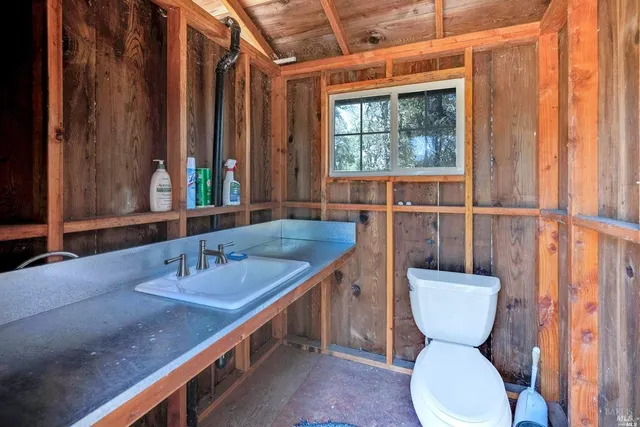 a bathroom with a toilet sink and mirror