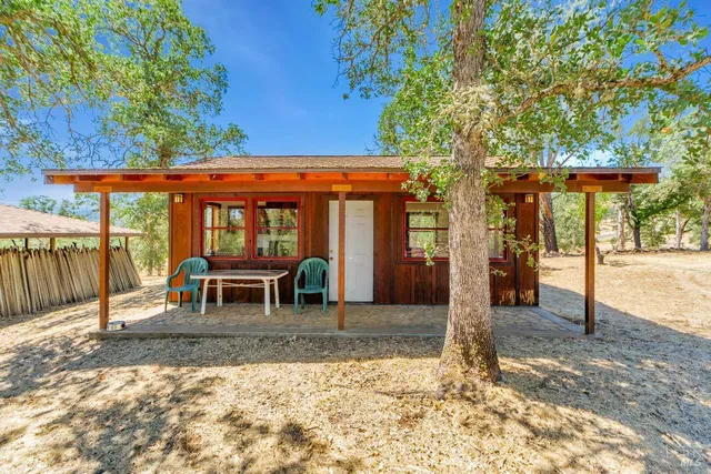 a view of a house with backyard porch and furniture