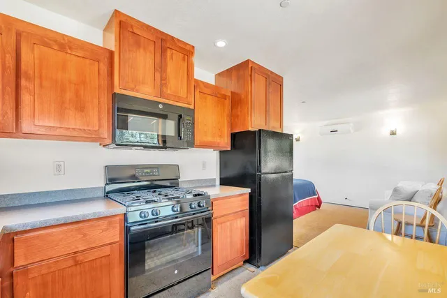 a kitchen with stainless steel appliances granite countertop a stove a sink dishwasher and a refrigerator
