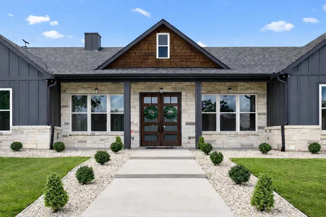 a front view of a house with a yard and porch