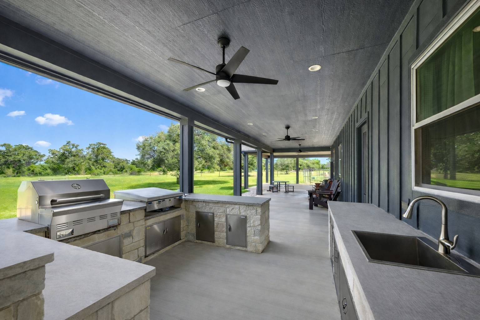 1507 Smith Rau Road Columbus, TX 78934 - Photo 22 of 42 a view of a kitchen with kitchen island a large window cabinets a sink and a counter top space