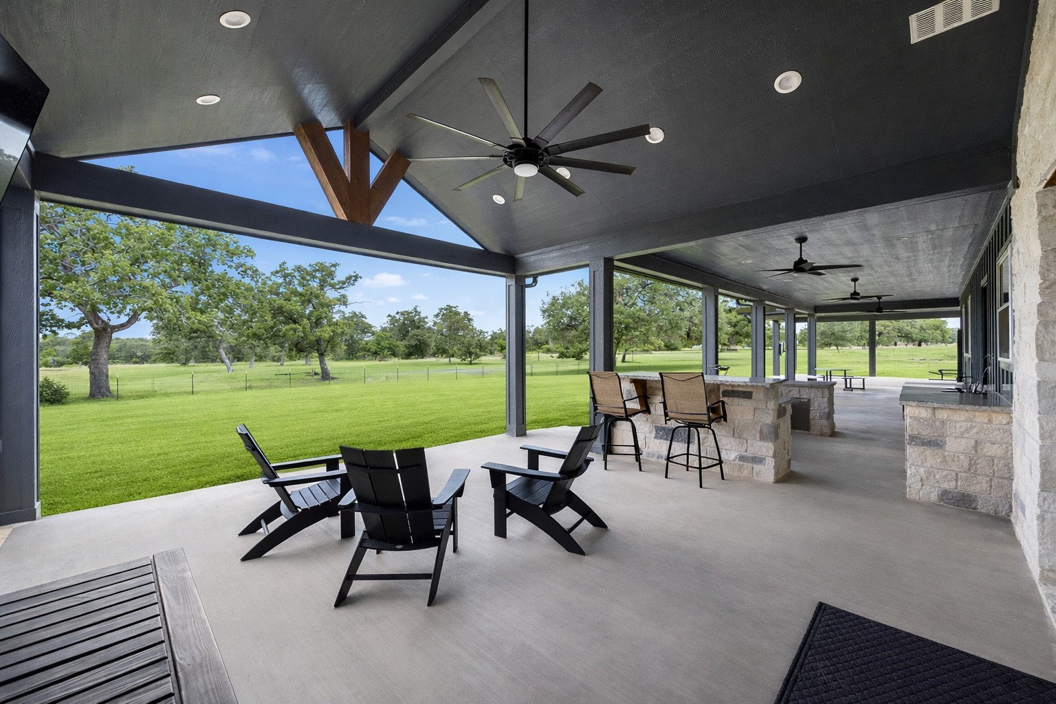 1507 Smith Rau Road Columbus, TX 78934 - Photo 23 of 42 a view of a patio with a table chairs and a backyard