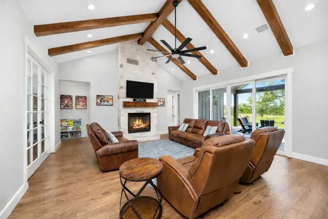 a living room with a bed and a large window