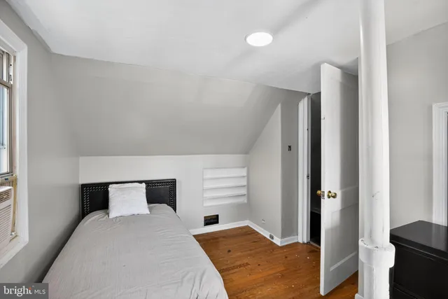 a bedroom with a bed and a window