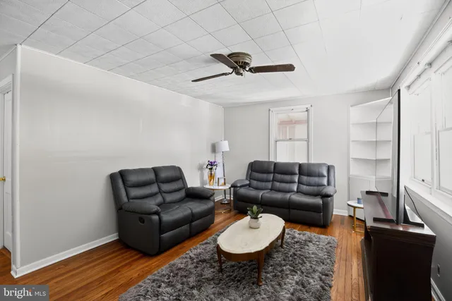a living room with furniture a rug and a window