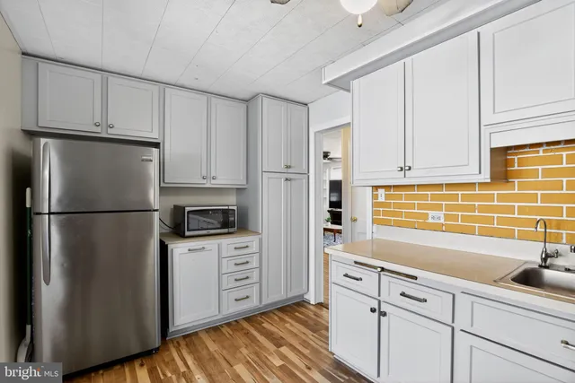 a kitchen with stainless steel appliances a refrigerator sink and cabinets