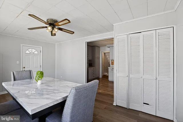 a view of a dining room with a table and chairs
