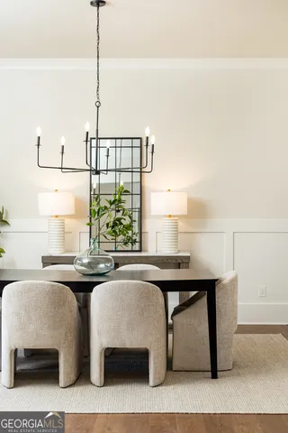 a bedroom with a large bed chandelier and a window