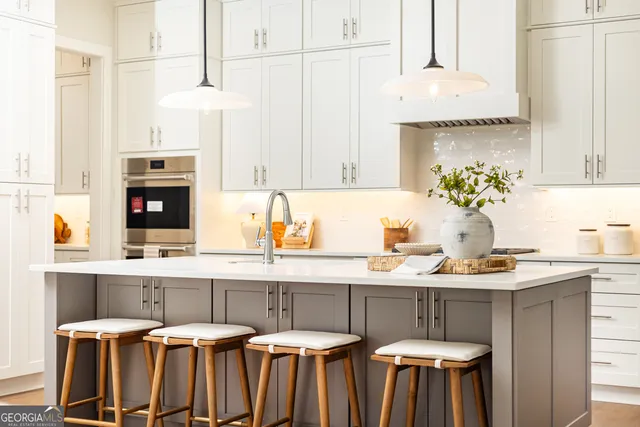 a spacious bathroom with a double vanity sink a mirror and a shower