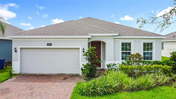 a front view of house with yard and trees