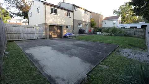 a view of a backyard with sitting area