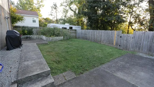 a view of a house with a yard and a garage
