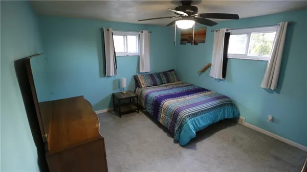 a bedroom with a bed and a chair