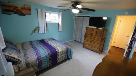 a bedroom with a bed and a mirror on dresser