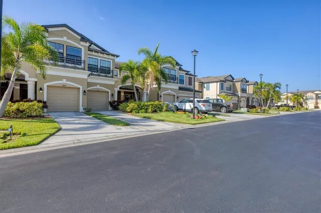 a view of a house with a swimming pool and a yard