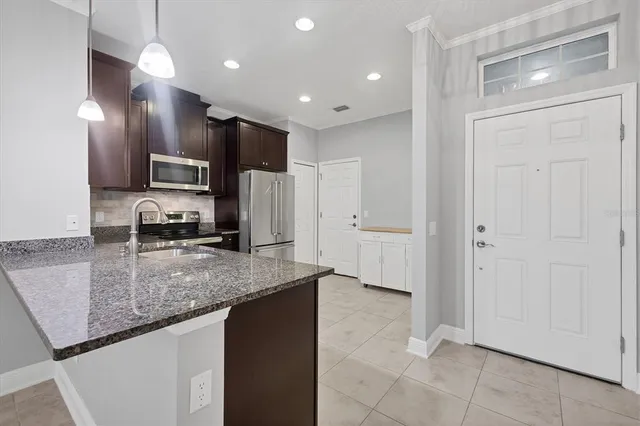 a view of a kitchen with a sink and a refrigerator