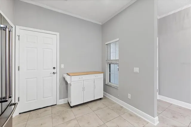 a view of a kitchen with white cabinets