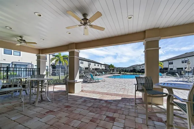 a view of a patio with a dining table and chairs