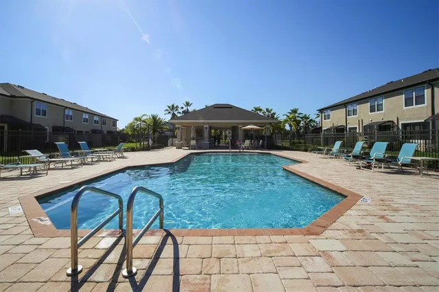 a swimming pool with outdoor seating and yard
