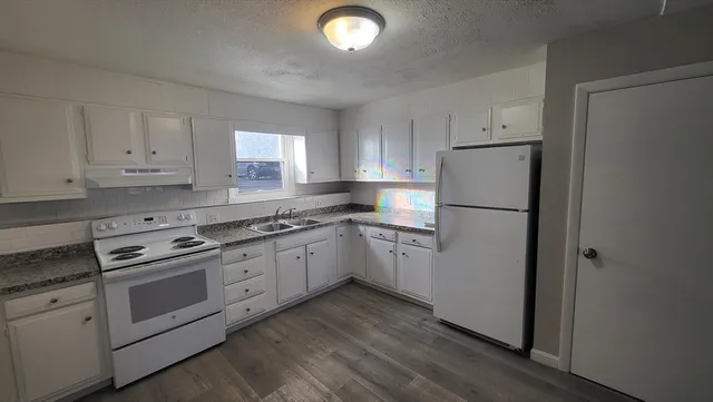 a kitchen with a refrigerator a stove a microwave and cabinets