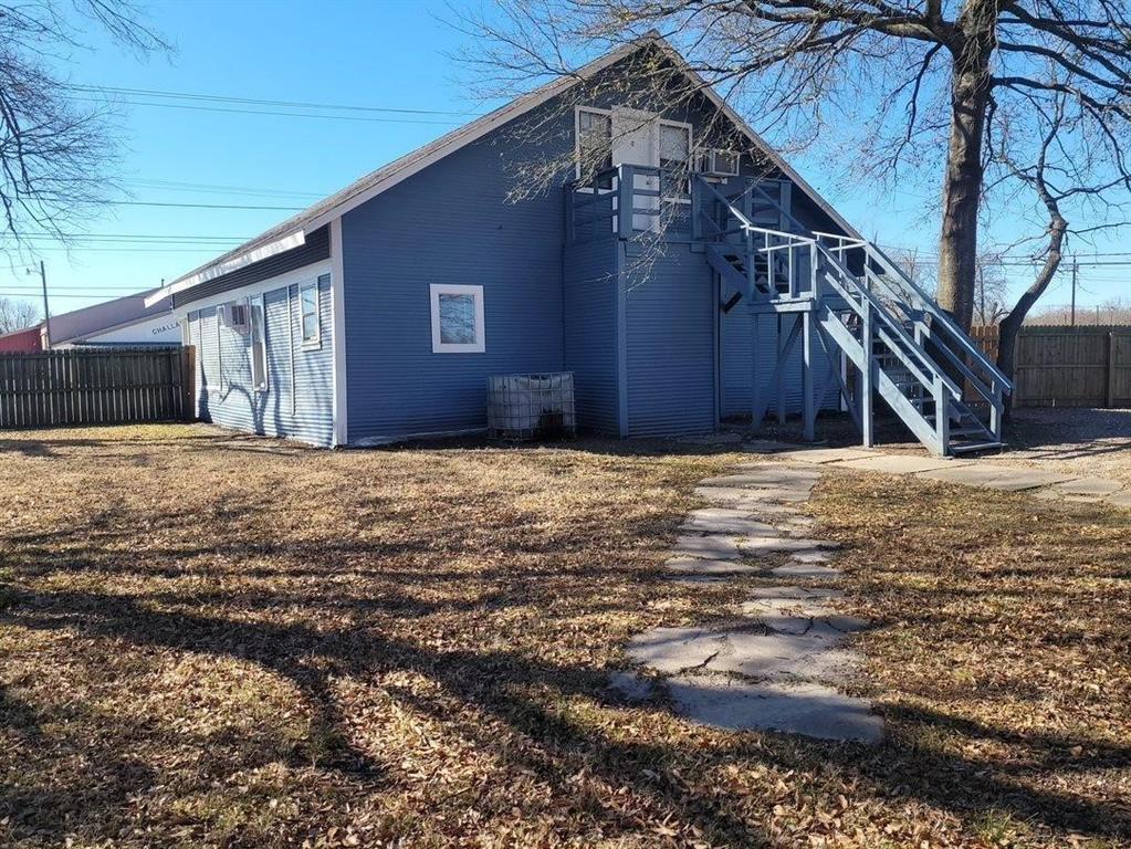 1103 East Moore Avenue, Unit 1 Terrell, TX 75160 - Photo 6 of 12 Back of house with fence and stairs