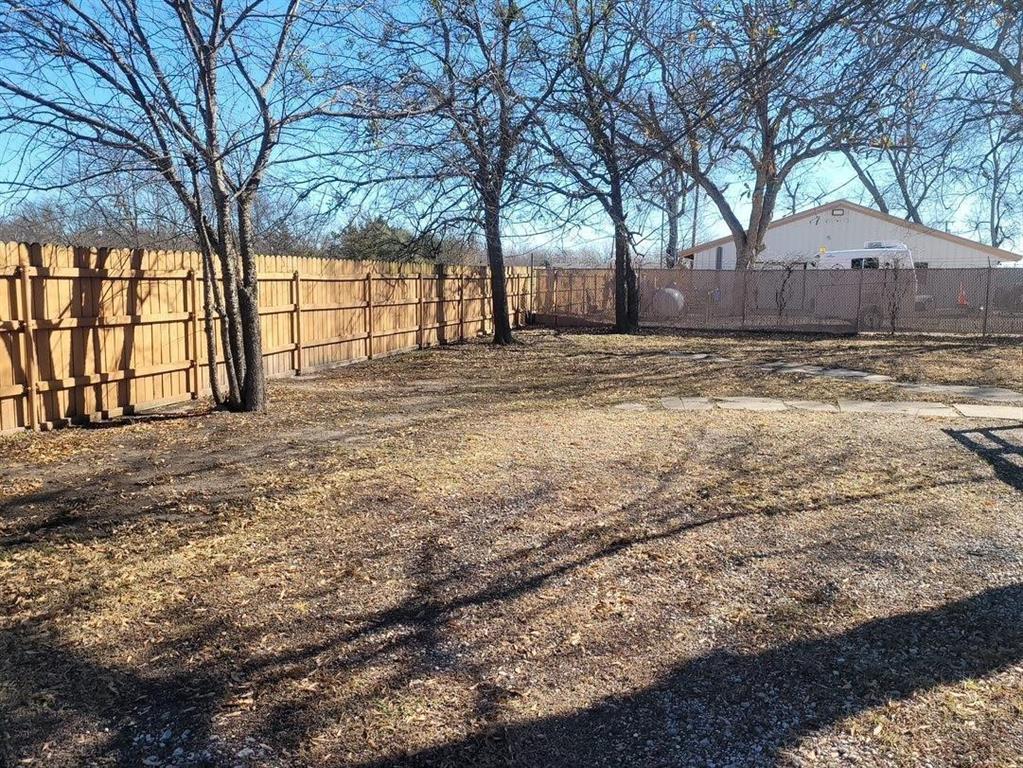 1103 East Moore Avenue, Unit 1 Terrell, TX 75160 - Photo 7 of 12 View of yard featuring fence private yard