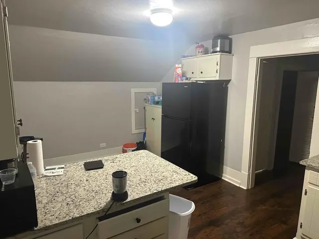 a large bed sitting in a bedroom next to a window and dresser