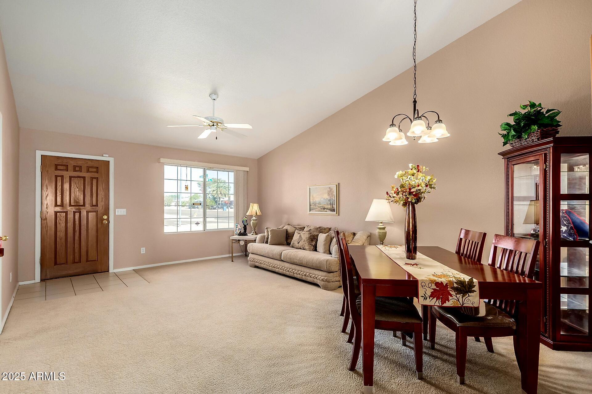 a dining room with furniture a chandelier and window