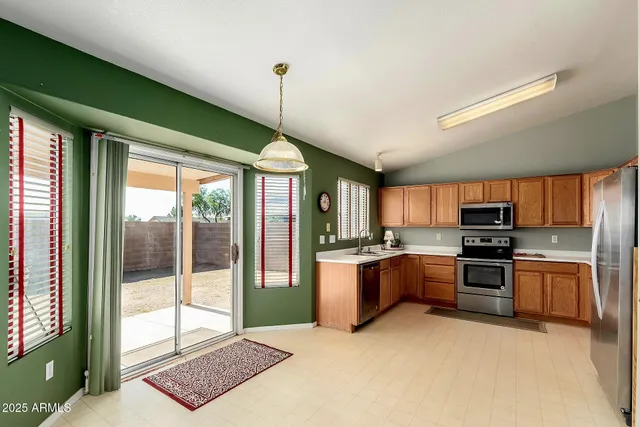 a view of walk in closet with clothes