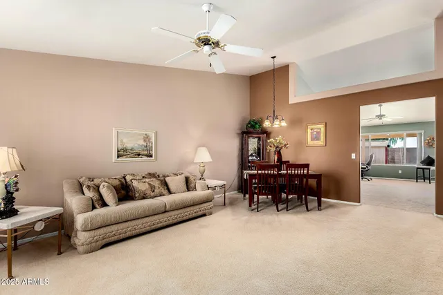 a living room with furniture and a chandelier