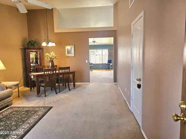 a living room with furniture a chandelier and a window