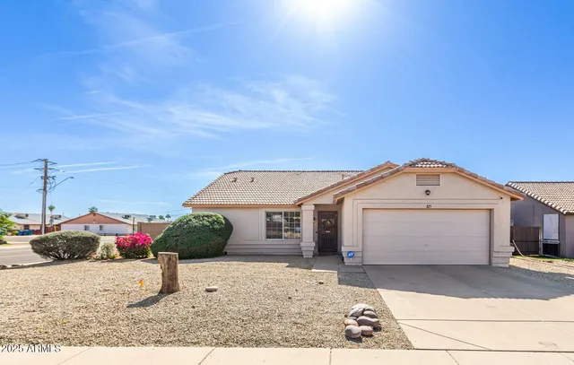 a kitchen with stainless steel appliances kitchen island granite countertop a refrigerator a stove and a sink with granite countertops