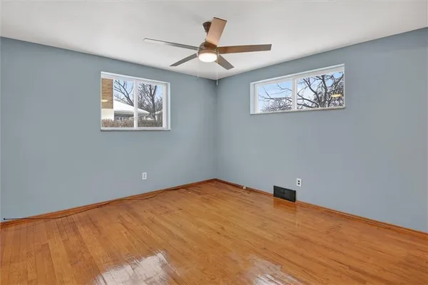 a view of an empty room with a painting on the wall