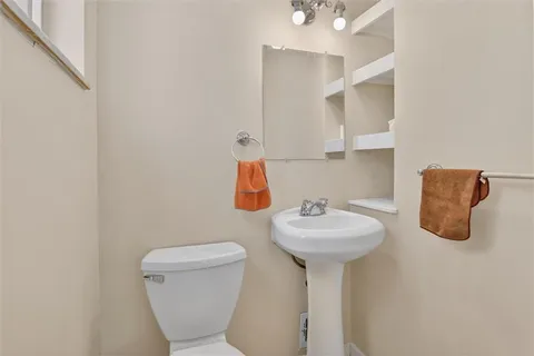 a bathroom with a sink mirror and toilet